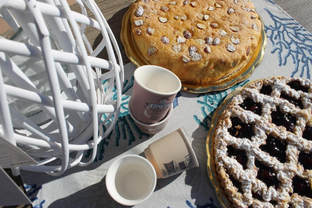 a table with three pies and two cups of coffee at M@re Nostrum & Co. in Campora San Giovanni