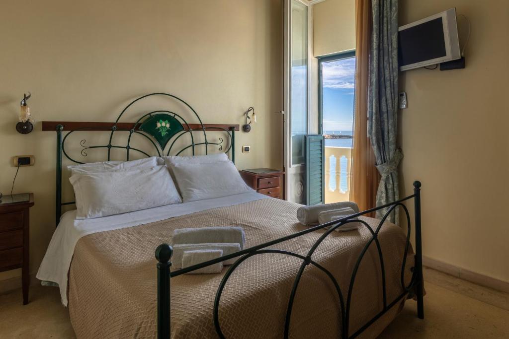 a bedroom with a bed with a view of the ocean at B&B La Riviera in Gallipoli
