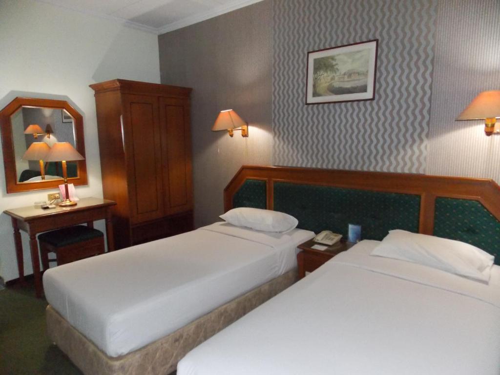 Postel nebo postele na pokoji v ubytování Puri Mega Hotel