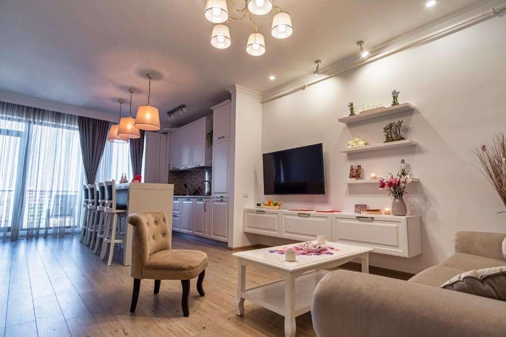 a living room with a couch and a table at Oasis by the Lake - Solid Residence Mamaia Apartment in Mamaia