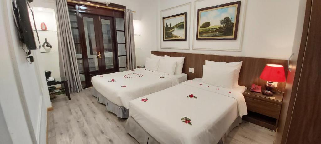 Postel nebo postele na pokoji v ubytování Hanoi Endless Hotel