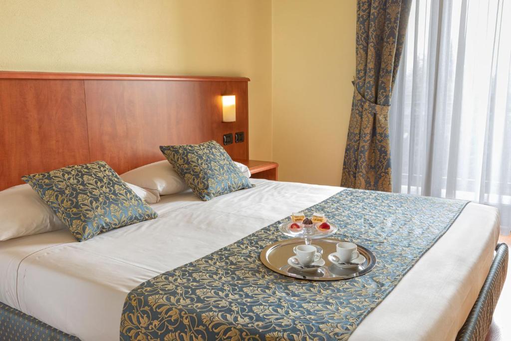Postel nebo postele na pokoji v ubytování Hotel Postumia