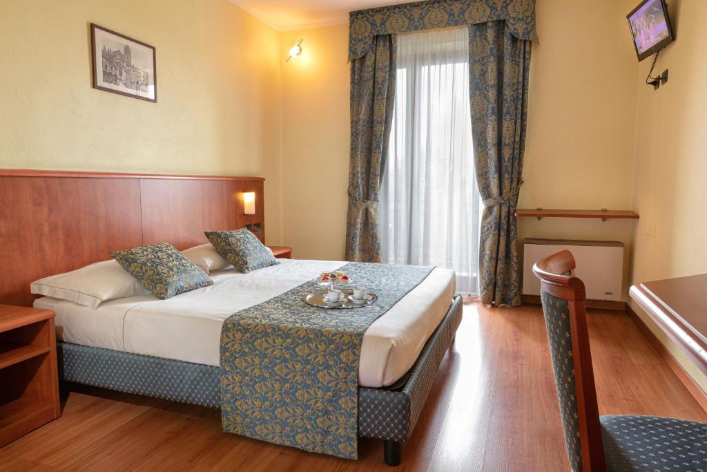 Postel nebo postele na pokoji v ubytování Hotel Postumia