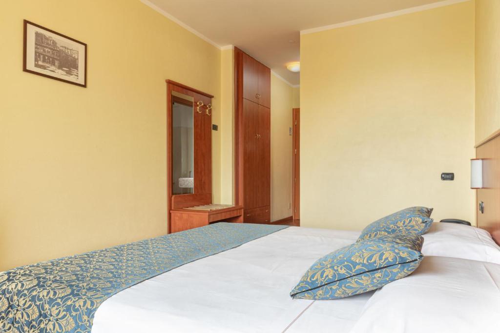 Postel nebo postele na pokoji v ubytování Hotel Postumia