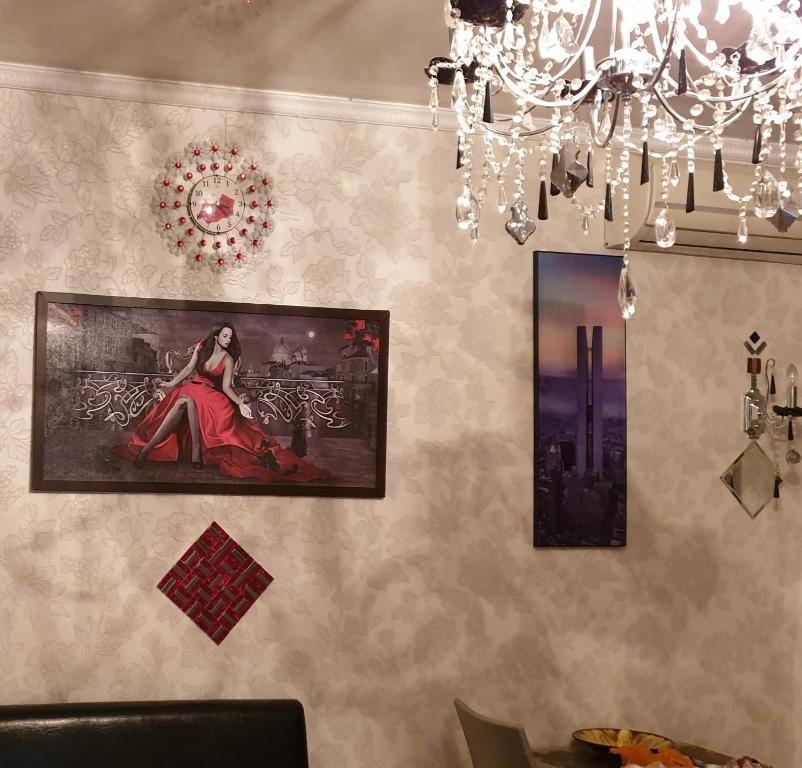 a wall with a painting of a woman in a red dress at Квартира в центре Сочи в первых домах от моря с евродизайнерским ремонтом in Sochi