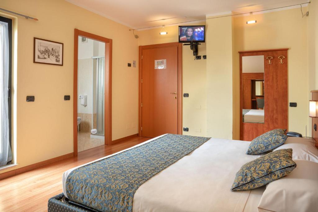 Postel nebo postele na pokoji v ubytování Hotel Postumia