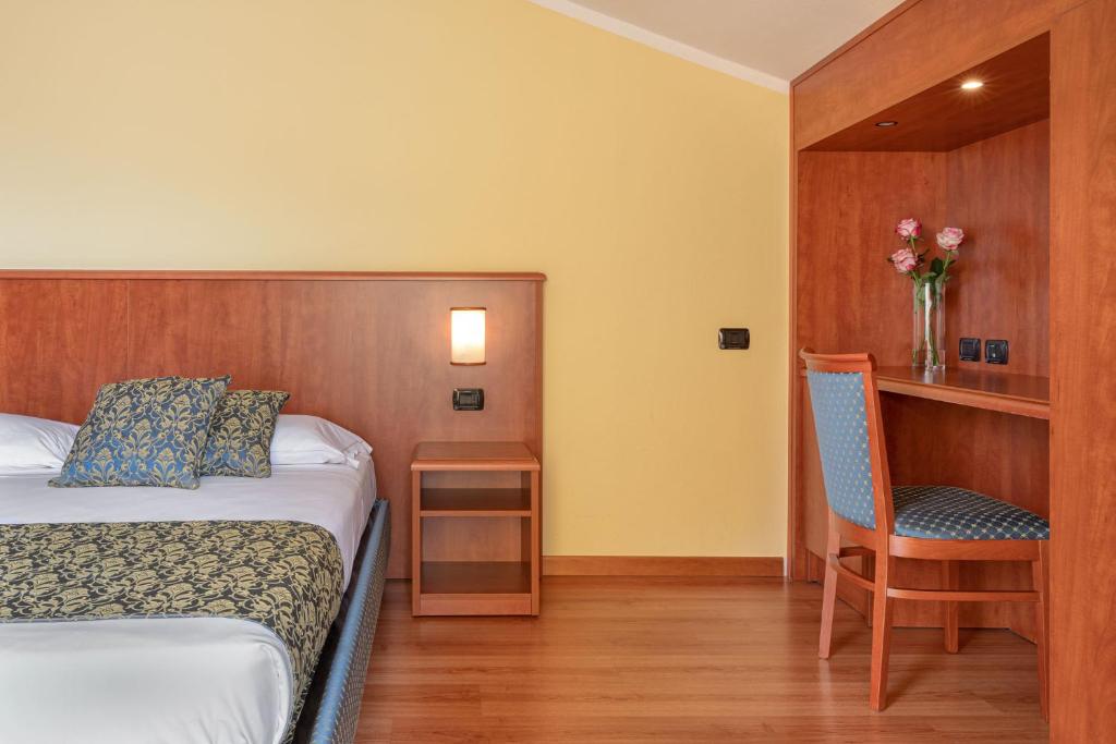 Postel nebo postele na pokoji v ubytování Hotel Postumia
