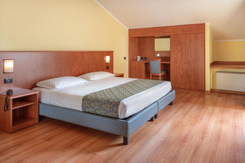 Postel nebo postele na pokoji v ubytování Hotel Postumia