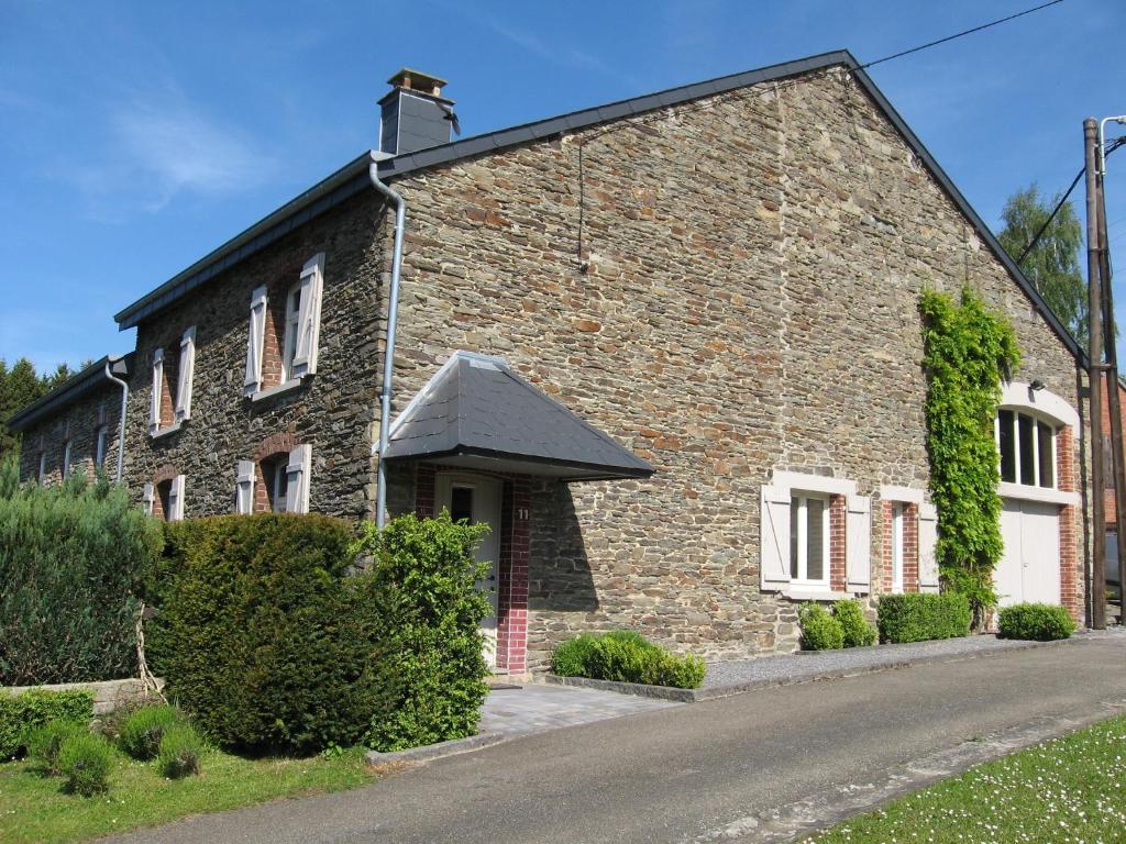 an old brick house with a road in front of it at Bordo Village in Bièvre