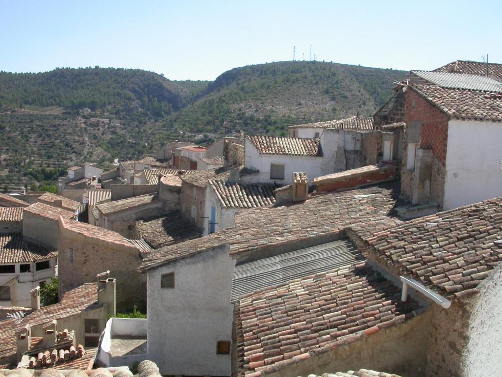 a group of buildings with mountains in the background at El Portal in Letur