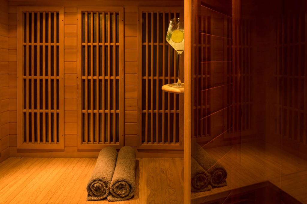 a bathroom with a shower with a towel on the floor at Above Blue Suites in Imerovigli