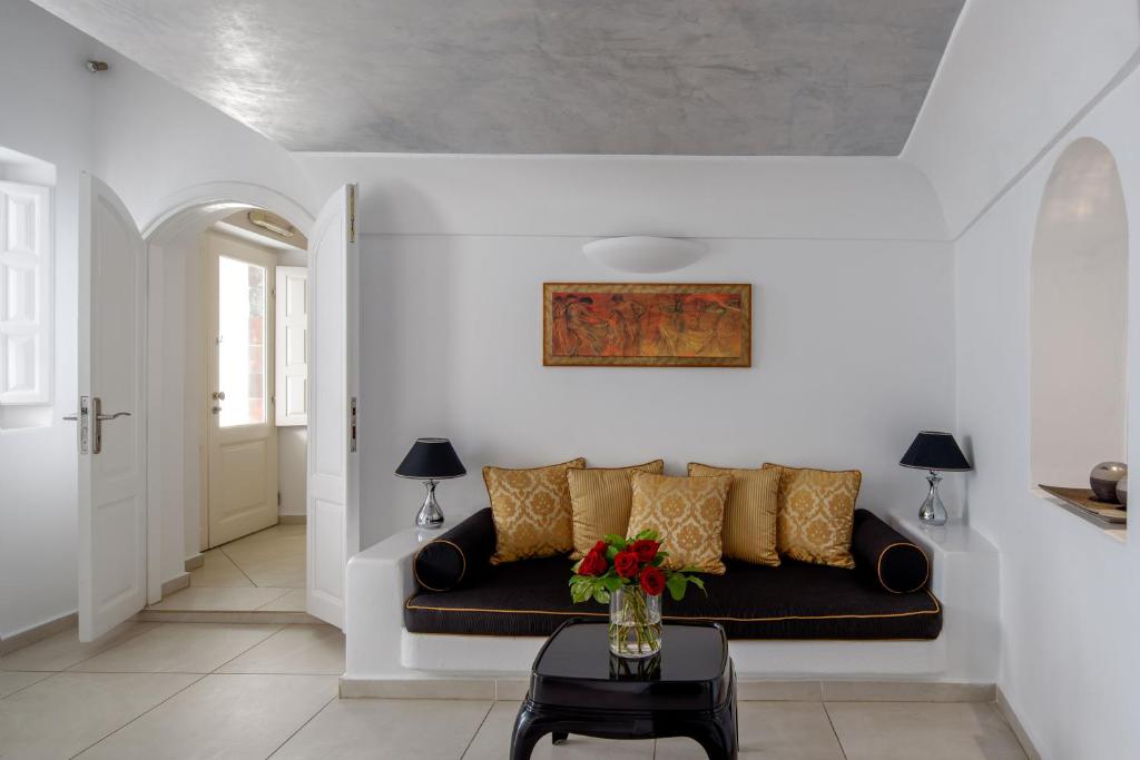 a living room with a couch and a table at Above Blue Suites in Imerovigli