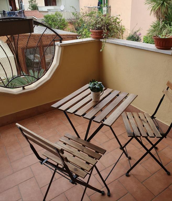 a picnic table and two chairs on a patio at Mary House in Ladispoli