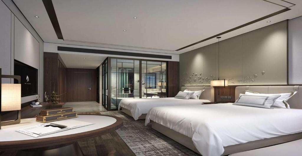 a hotel room with two beds and a table at Days Hotel by Wyndham Binjiang Changsha in Changsha
