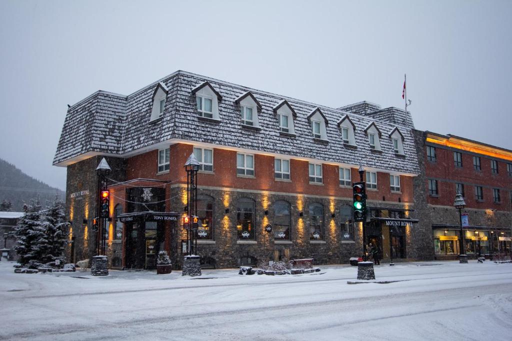a large red brick building with a large roof at Mount Royal Hotel in Banff
