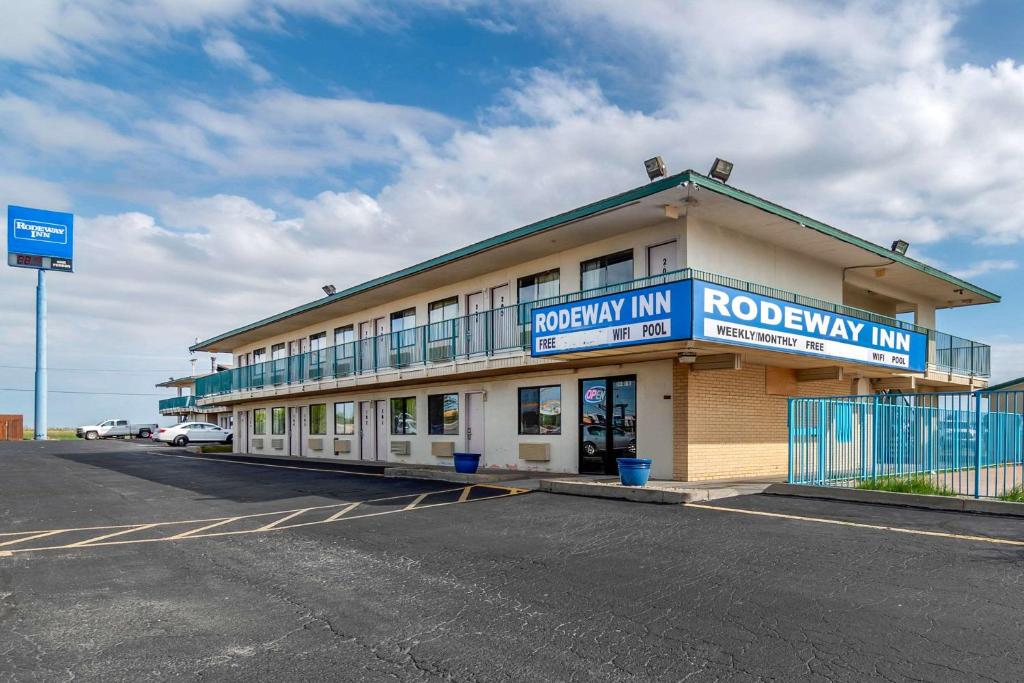 a building with a parking lot in front of it at Rodeway Inn in Hays