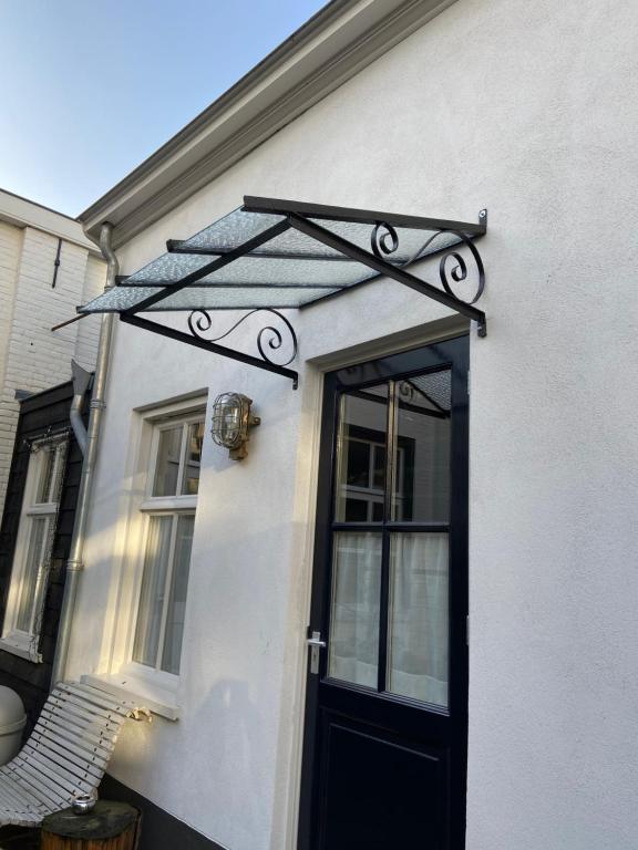 a black door with a metal frame on a house at Mini appartement De Fabriek in Nijmegen