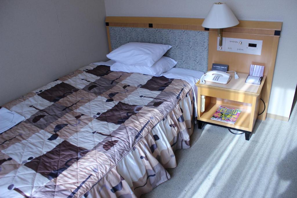 Postel nebo postele na pokoji v ubytování Grand Hotel Hakusan