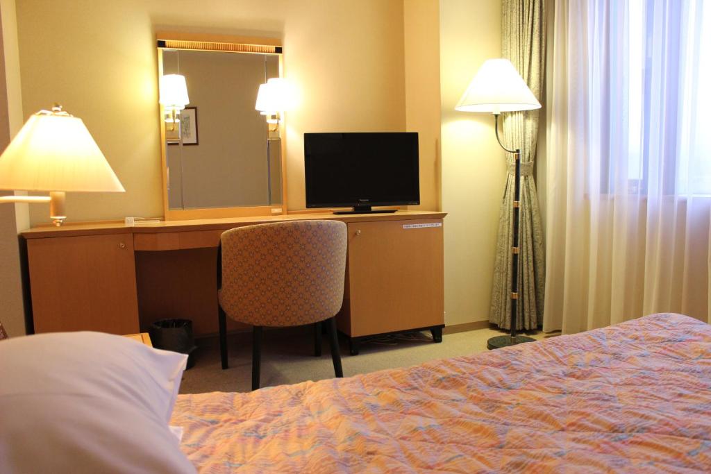 Postel nebo postele na pokoji v ubytování Grand Hotel Hakusan