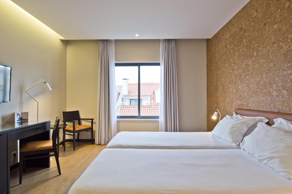 Uma cama ou camas num quarto em LAM Hotel Estarreja
