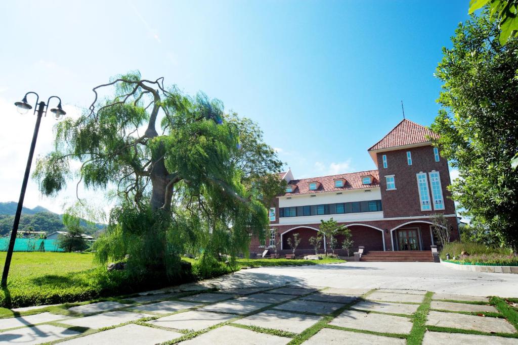 an old building with a tree in front of it at Schokolake Country House in Dahu