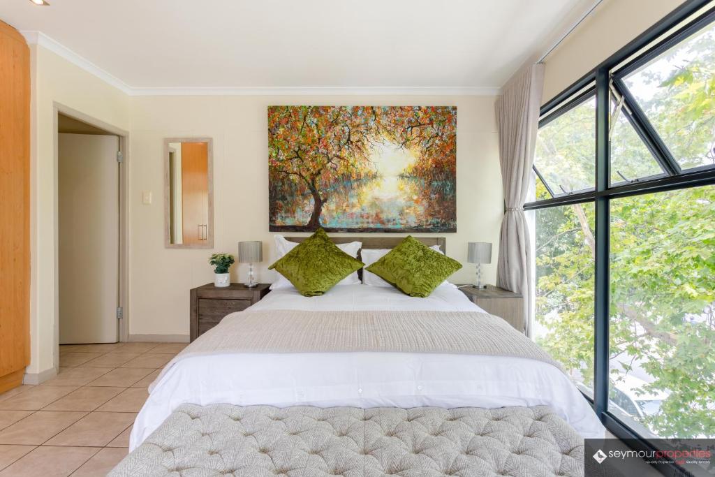 a bedroom with a large bed and a large window at CONCORD APARTMENTS Unit 1 in Stellenbosch
