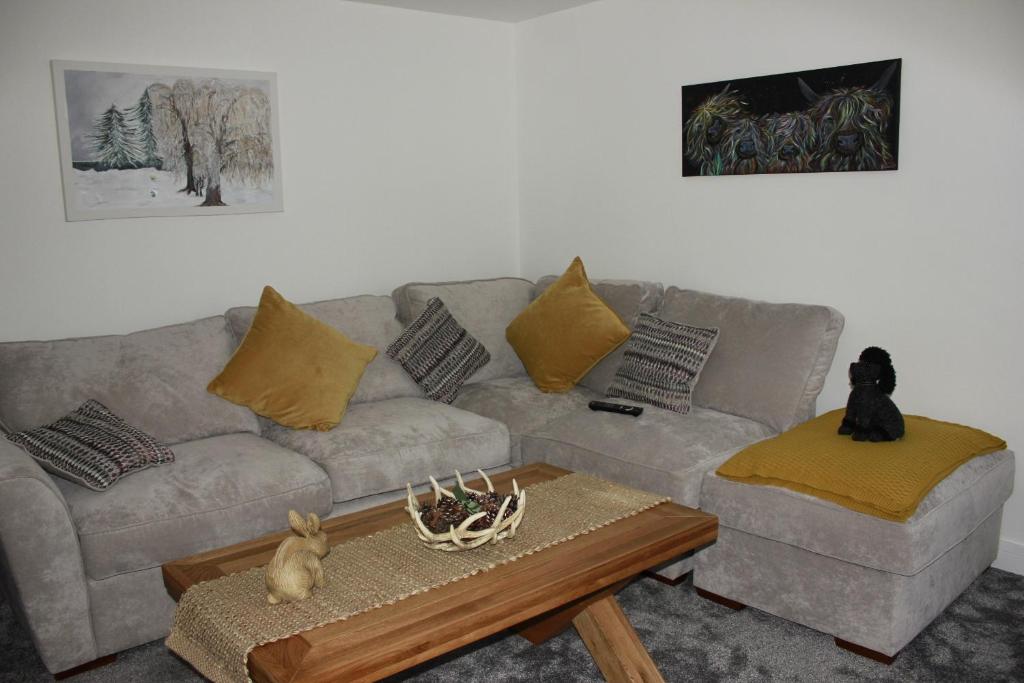 a living room with a couch and a coffee table at Ground Floor Apartment in Montrose