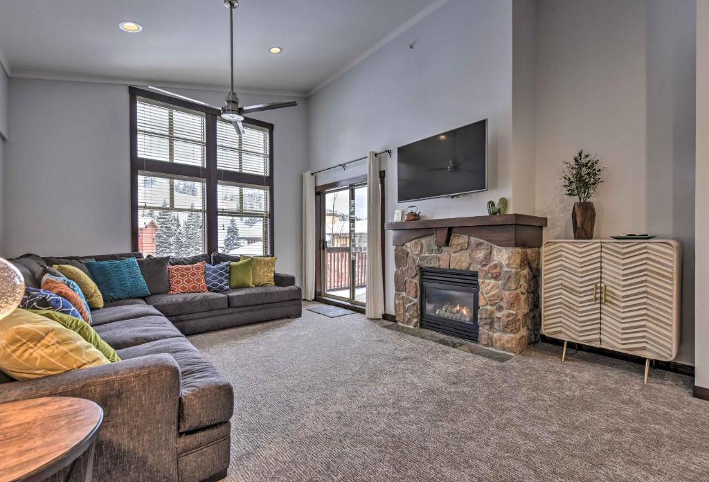 a living room with a couch and a fireplace at Slopeside Solitude Condo - Walk to Ski Lifts! in Solitude