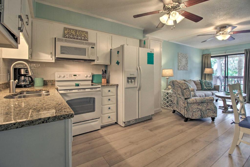 a kitchen with white appliances and a living room at Villa with Prime Location Walk to Beach and Coligny! in Hilton Head Island