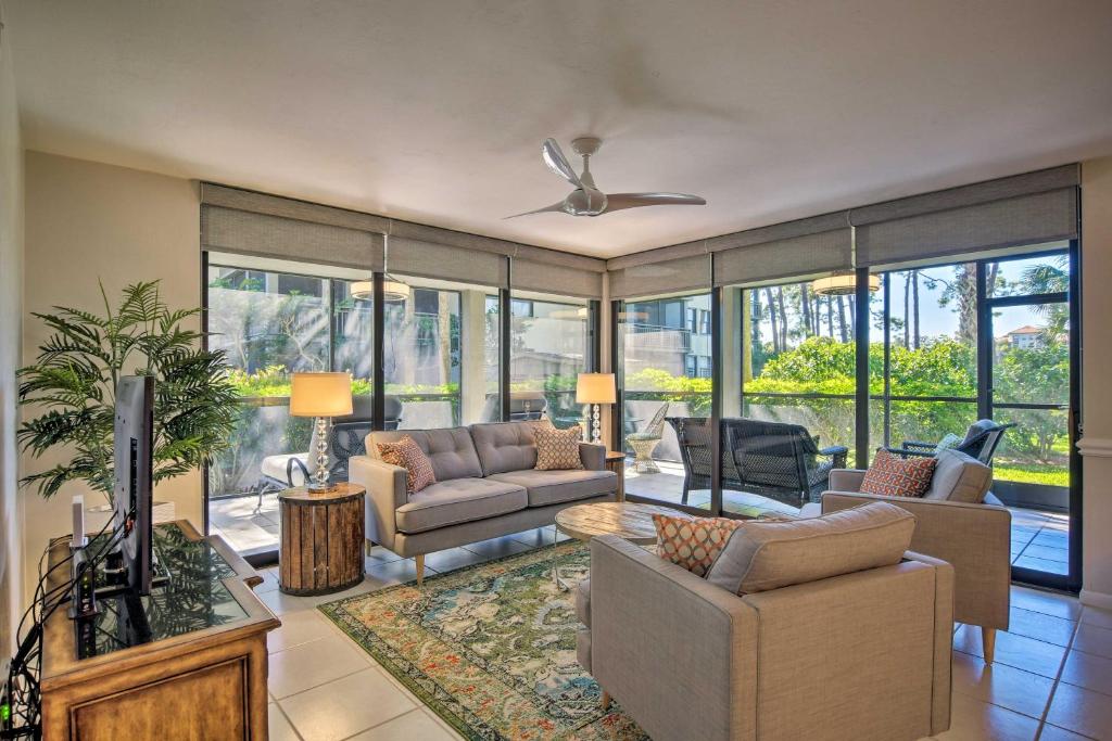 a living room with a couch and a tv at Bonita Springs Condo 4 Mi to Beach Private Patio! in Bonita Springs