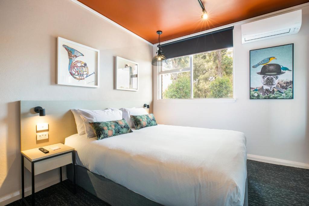 a bedroom with a white bed and a window at Nightcap at Fairfield in Fairfield