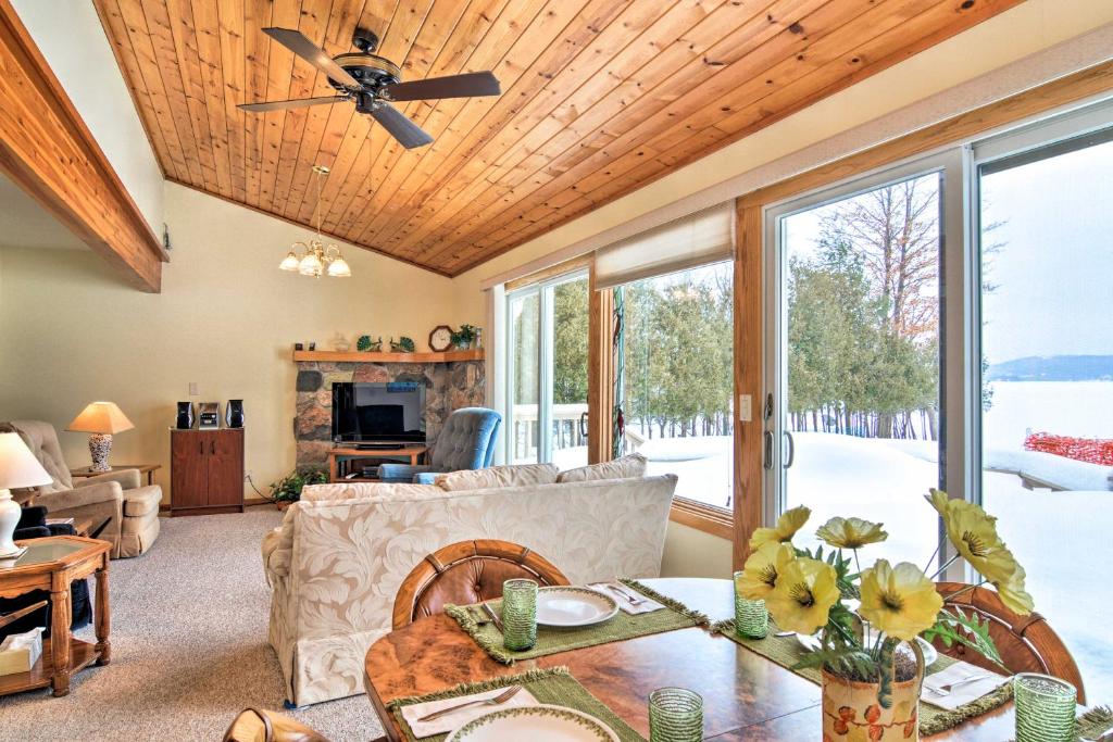 a living room with a couch and a ceiling fan at Cedar Cottage, Private Beach on Lake Leelanau in Cedar