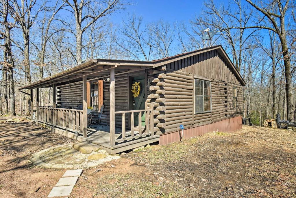 a log cabin with a porch and a door at Arkansas Log Cabin Rental Near Lake Greeson! in Mount Moriah