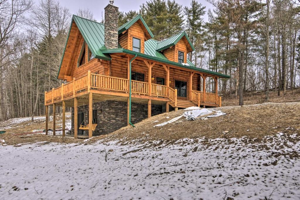 a large wooden house with a green roof at Family-Friendly Warsaw Cabin with Deck and Fireplace! in Warsaw