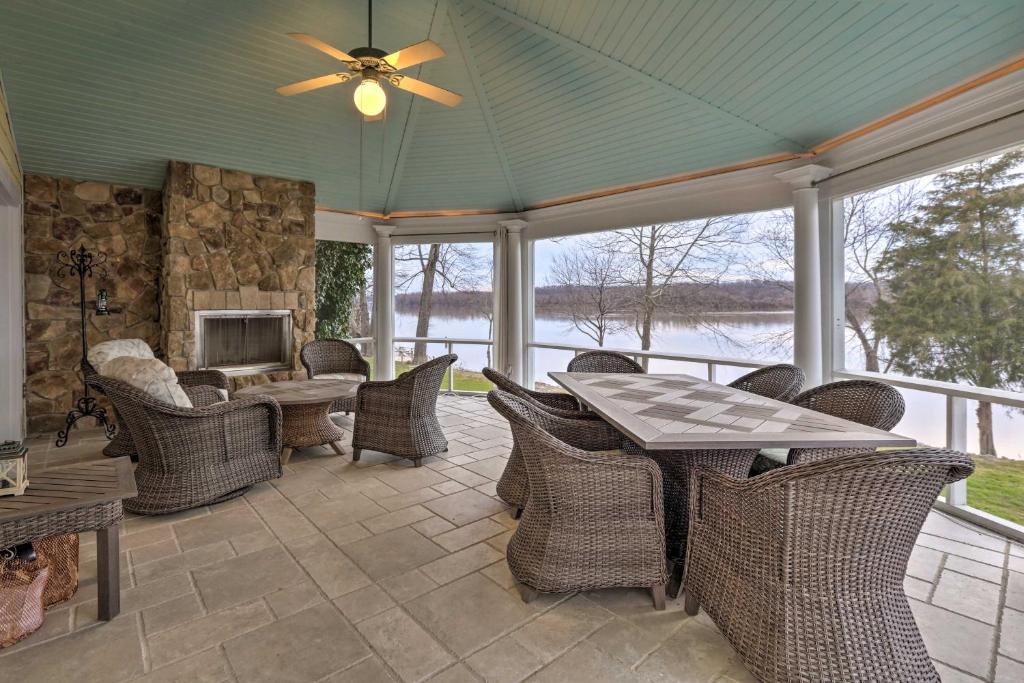 a screened in porch with a table and chairs at Waterfront Vacation Rental Near Louisville! in Prospect