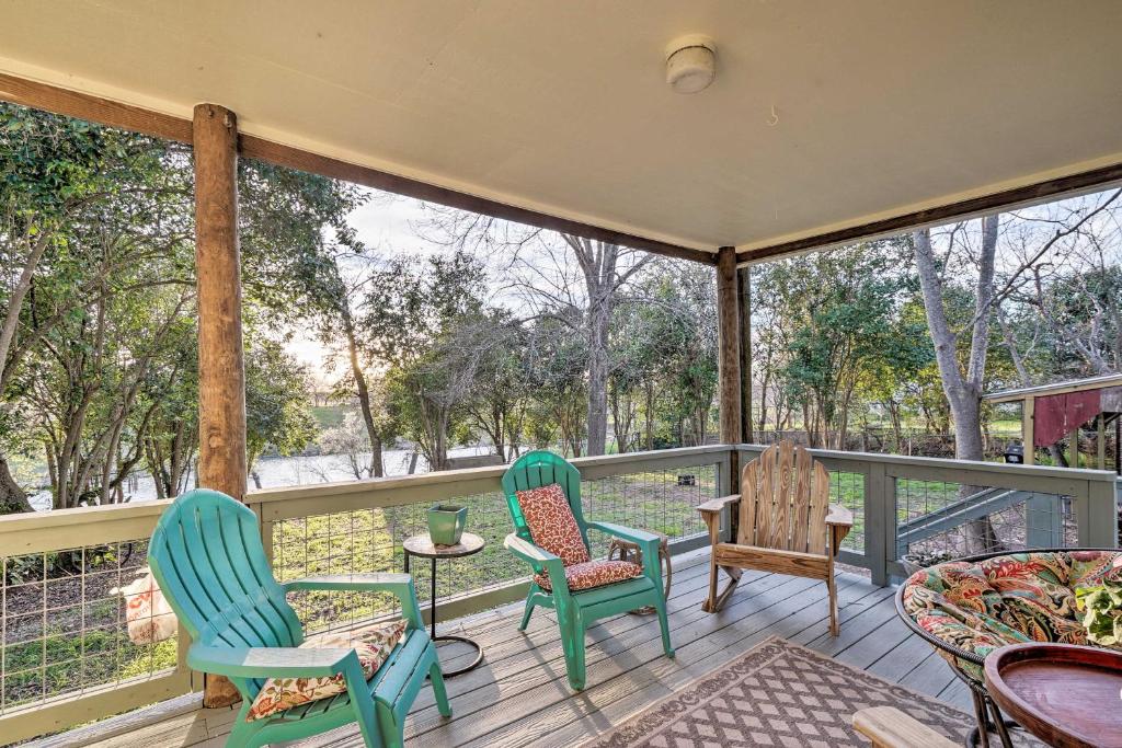 a porch with three chairs and a table on it at Riverfront Martindale House with 2 Covered Decks in Martindale