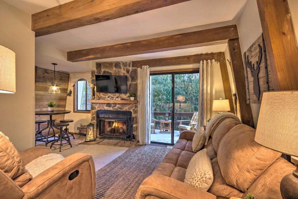 a living room with a couch and a fireplace at Rustic Banner Elk Getaway about 1 Mi to Sugar Mountain in Banner Elk