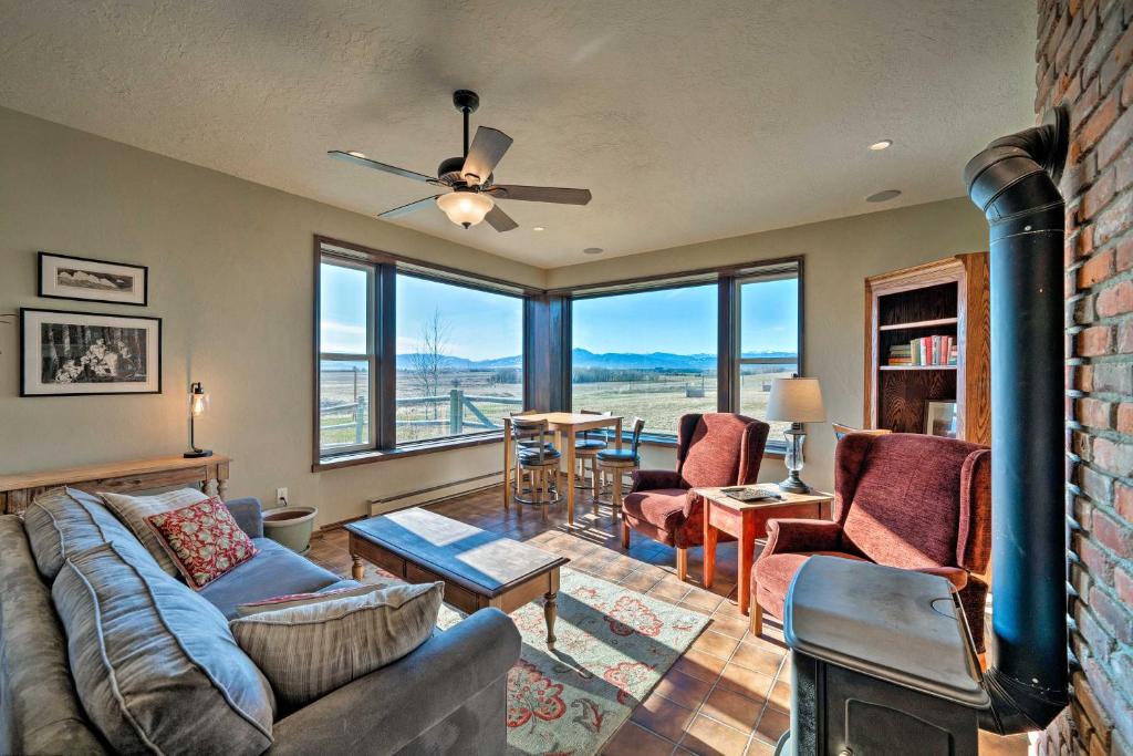 a living room with a couch and a fireplace at Bozeman Home on 11 Acres with Mountain Views! in Bozeman
