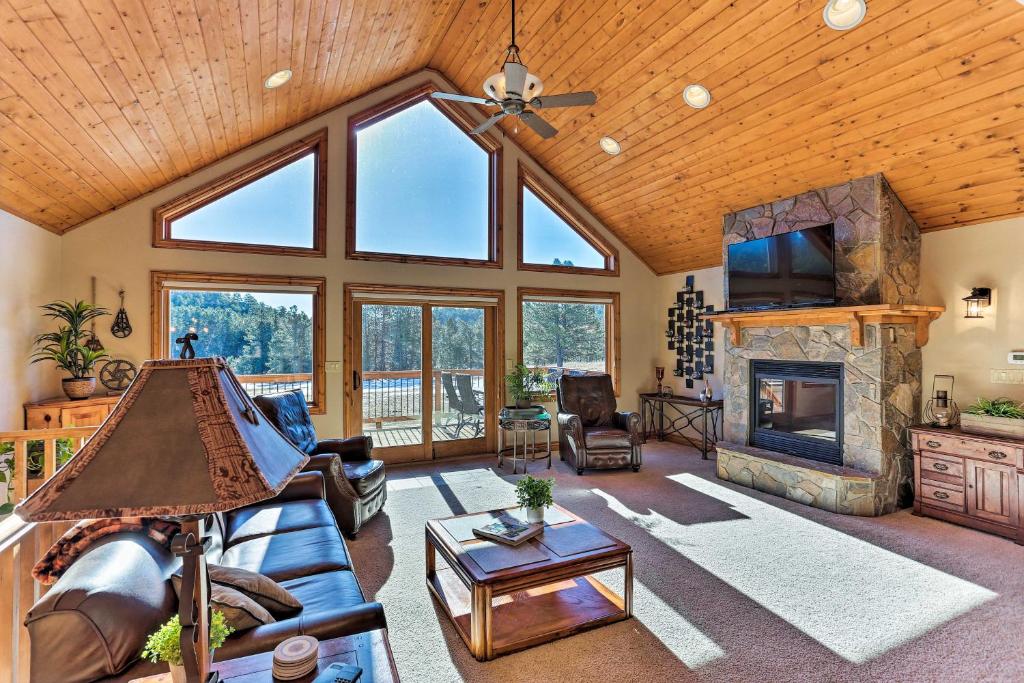 a living room with a couch and a fireplace at Cabin with Deck and Fire Pit, 9 Mi to Mt Rushmore! in Keystone