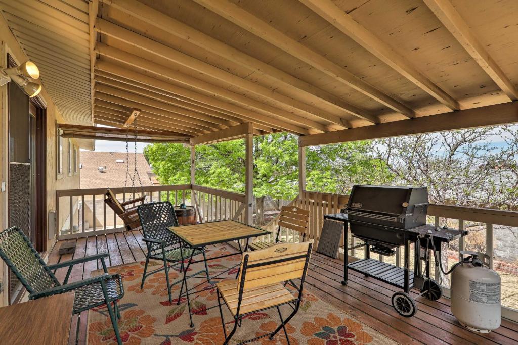 a porch with a piano and a table and chairs at Page Home with Balcony and Yard, Walk to Rim View Trail in Page