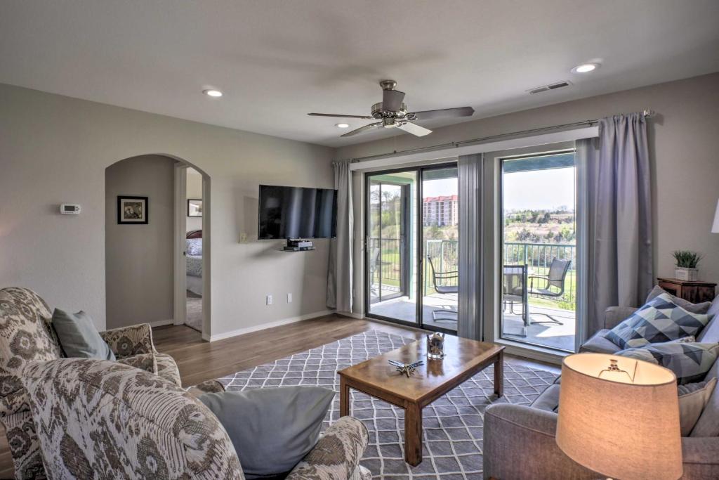 a living room with a couch and a table at Less Than 1 Mi to Branson Strip Condo on Golf Course! in Branson