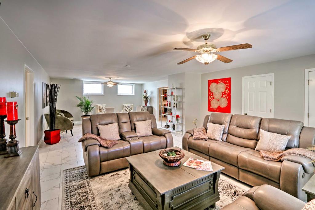 a living room with couches and a ceiling fan at Quiet Memphis Home on 20 Acres 10 Mi to Downtown! in Memphis