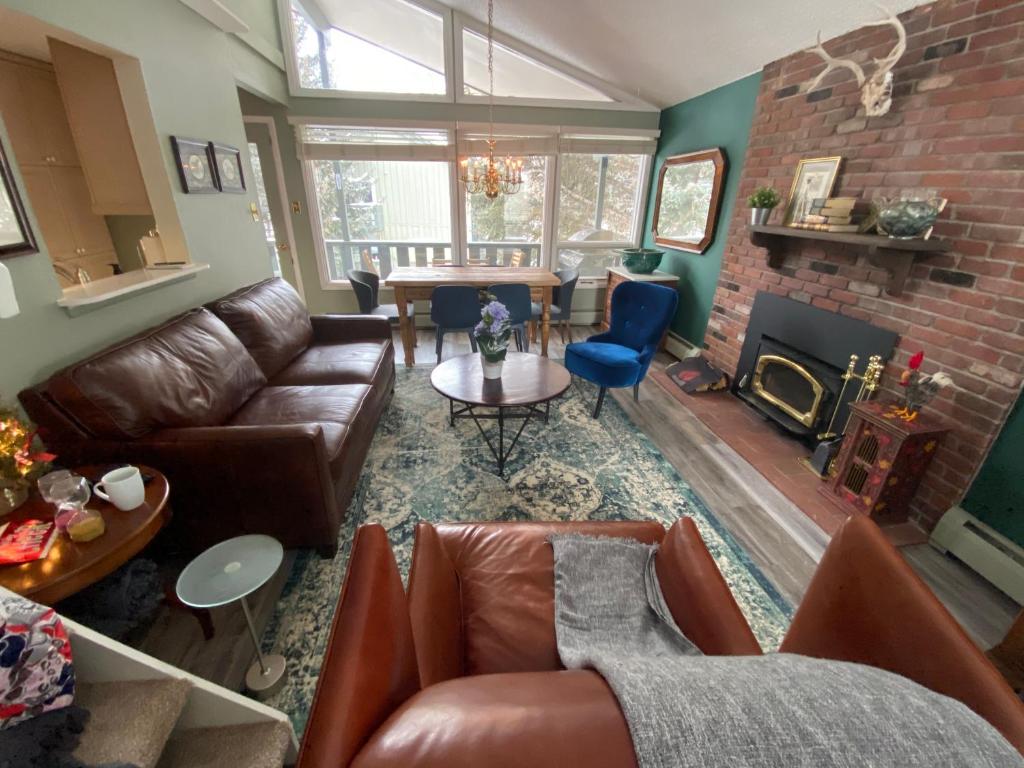 a living room with leather furniture and a fireplace at Spectacular apartment, close to Lions Head, next to bus stop in Vail