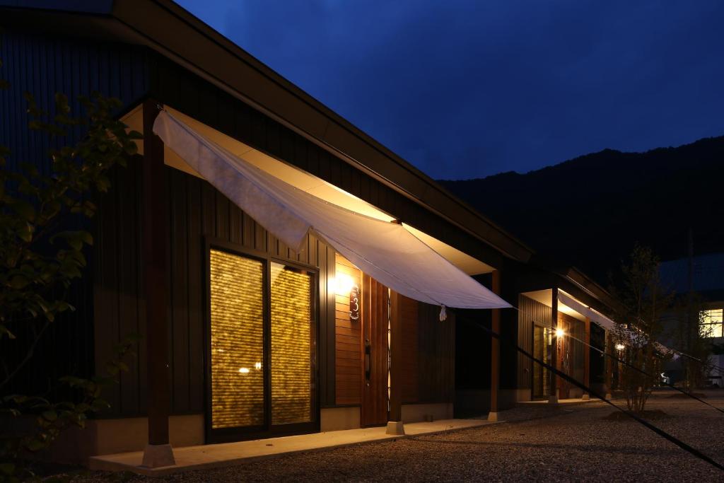 a building with awning on the side of it at night at Riner Stone in Minakami