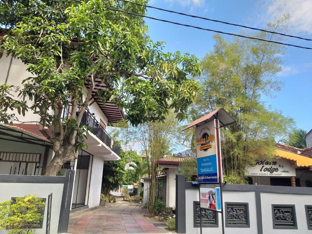 a street sign in front of a house at Golden Lodge Tangalle in Tangalle