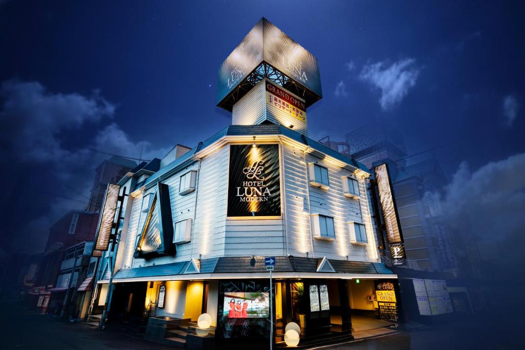 a building with a clock tower on top of it at HOTEL LUNA MODERN Sakuranomiya (Adult Only) in Osaka