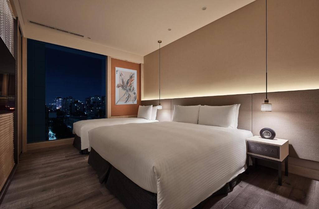 Postel nebo postele na pokoji v ubytování Parkview Taipei