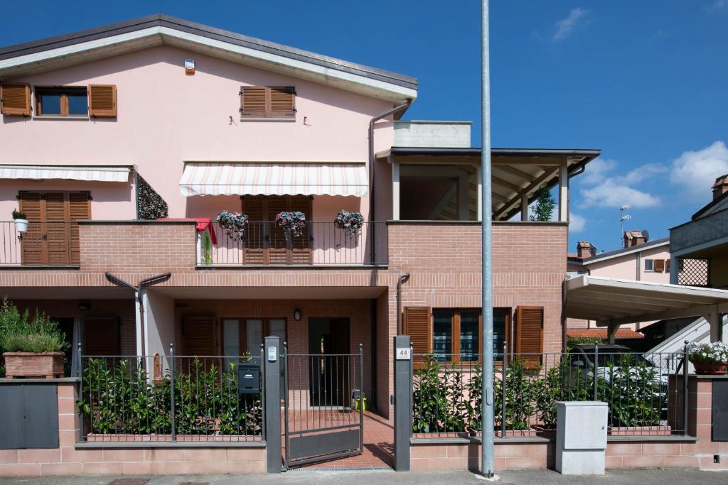 uma casa cor-de-rosa com uma varanda em Le Rime em Arezzo