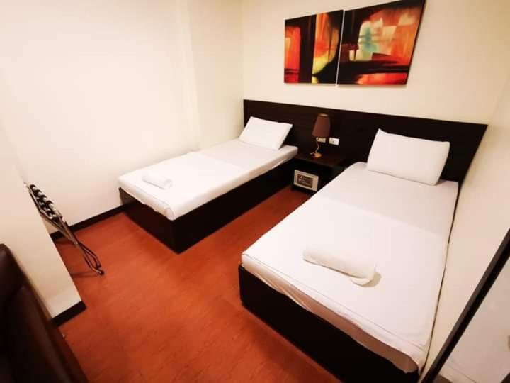Postel nebo postele na pokoji v ubytování Orchard Hotel Davao