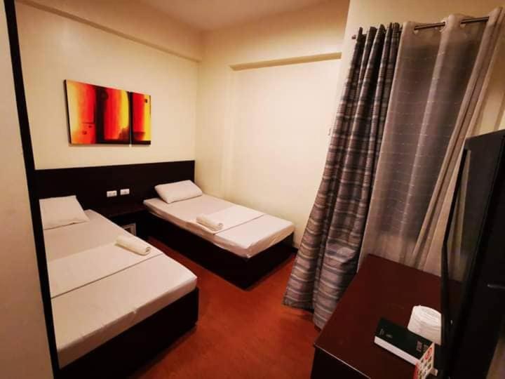 Postel nebo postele na pokoji v ubytování Orchard Hotel Davao